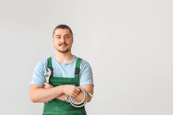 Handsome plumber on light background — Stock Photo, Image