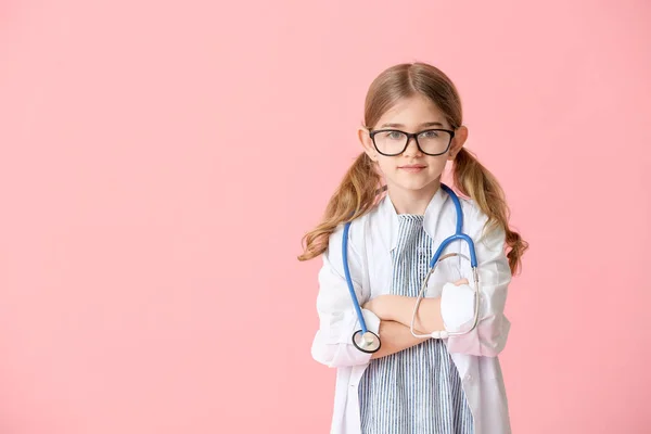 Cute little doctor on color background — Stock Photo, Image