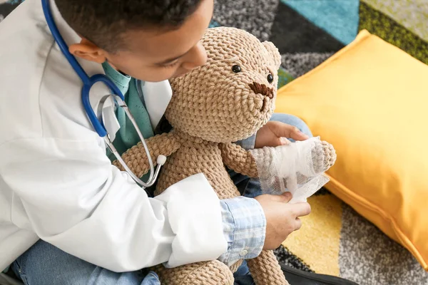 Cute little African-American boy playing doctor at home — Stock Photo, Image