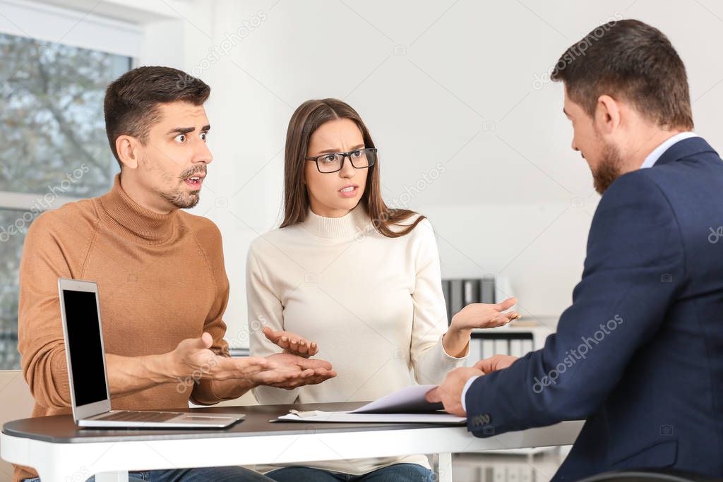 Displeased couple having meeting with bank manager in office
