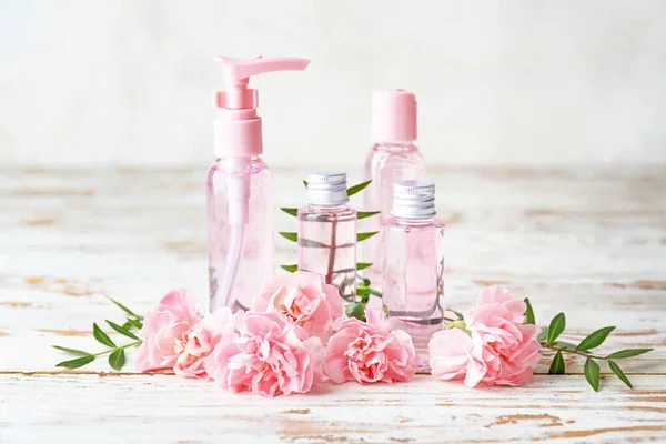 Produtos cosméticos diferentes em garrafas na mesa de madeira — Fotografia de Stock