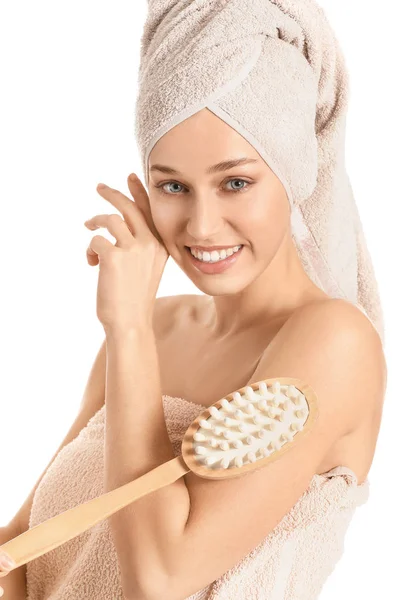 Beautiful young woman with massage brush on white background — Stock Photo, Image