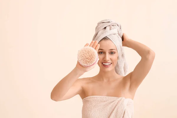 Beautiful young woman with massage brush on light background — Stock Photo, Image