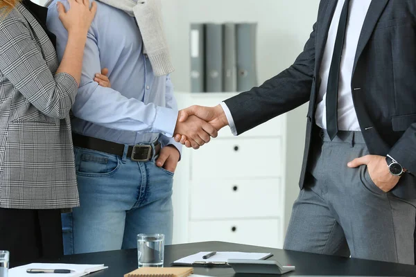 Bank manager and clients shaking hands in office — Stock Photo, Image