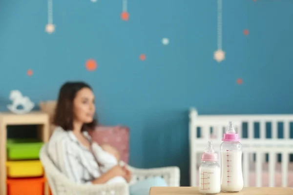 Bottles of milk on table in room — Stock Photo, Image