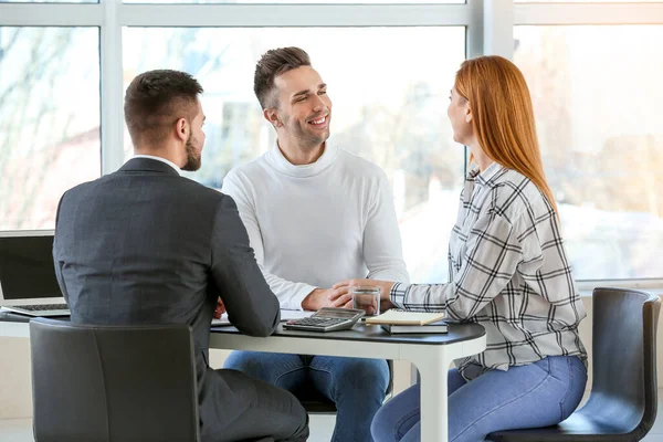 Bank manager working with clients in office