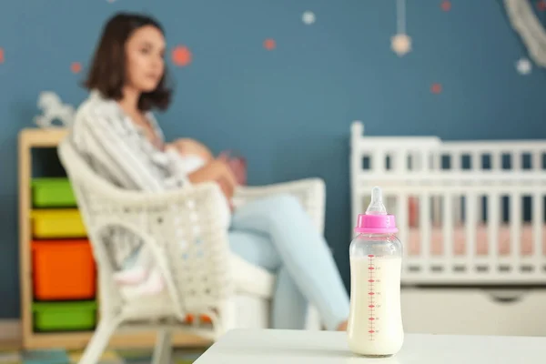 Bottle of milk on table in room — Stock Photo, Image