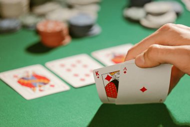 Man playing poker in casino, closeup