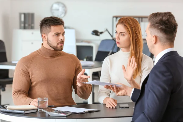 Bank manager working with displeased clients in office