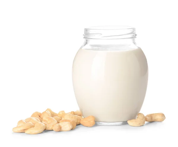 Jar of cashew milk with nuts on white background — 스톡 사진