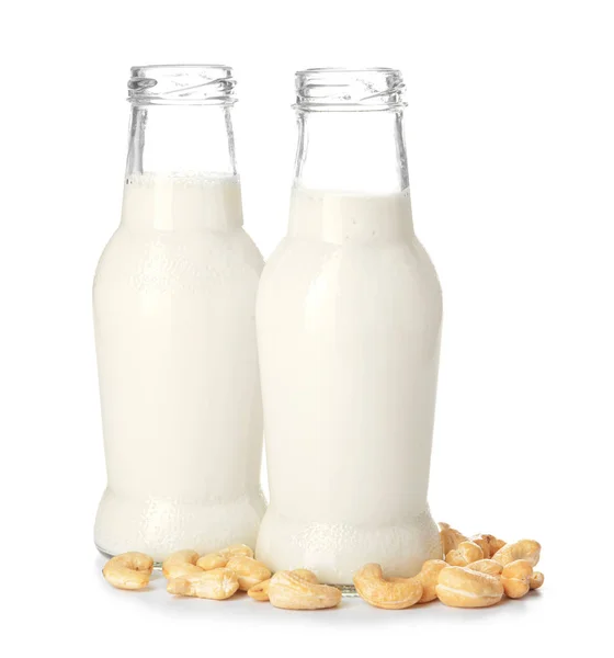 Bottles of fresh cashew milk on white background — 스톡 사진