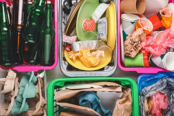 Baskets with different garbage on table, top view. Concept of recycling — Stock Photo, Image