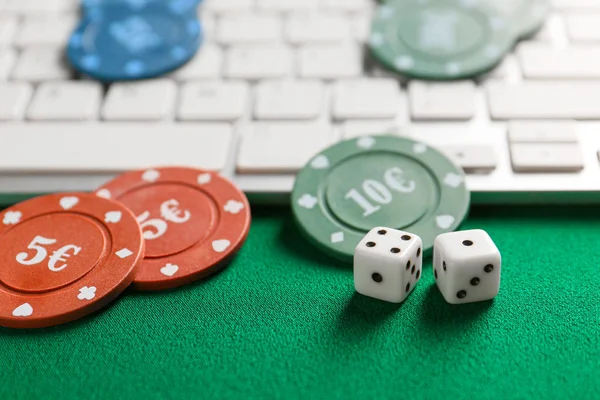 Chips for gambling games, dices with computer keyboard on color background — Stock Photo, Image