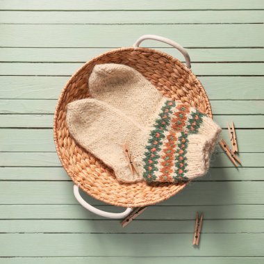 Çoraplı sepet ve tahta arka planda askılar.