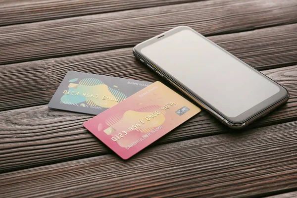 Cartões de crédito com telefone celular em fundo de madeira. Conceito de banco online — Fotografia de Stock