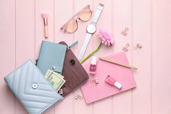 Purse with wallet, money, stationery and accessories on white wooden background — Stock Photo, Image
