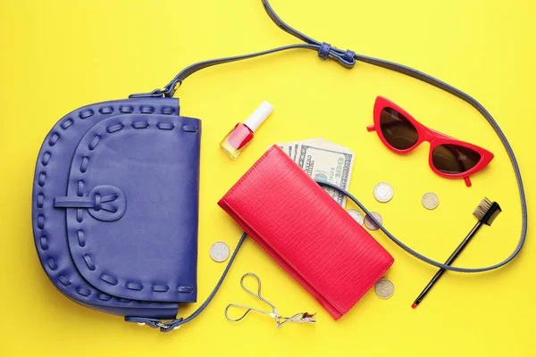 Purse with wallet, money and accessories on color background — 스톡 사진