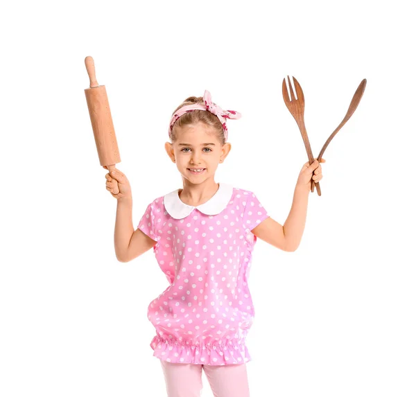 Little housewife with kitchen utensils on white background — Stock Photo, Image