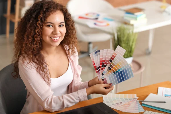 African-American designer with color palettes in office — Stock Photo, Image