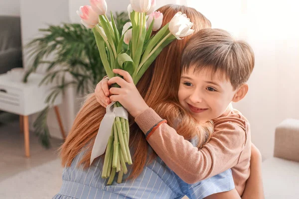 Woman receiving flowers from her little son on Mother's Day — Stock Photo, Image