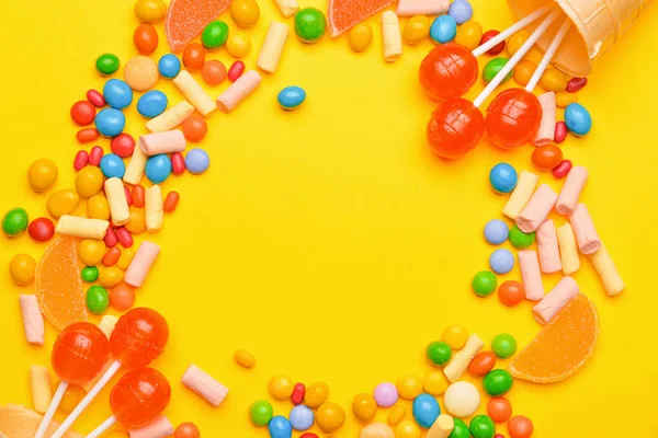 Frame made of tasty candies on color background — Stock Photo, Image