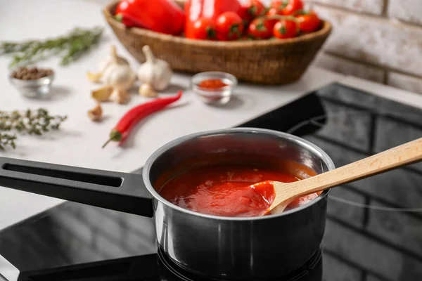 Preparing of tomato sauce in saucepan — Stock Photo, Image