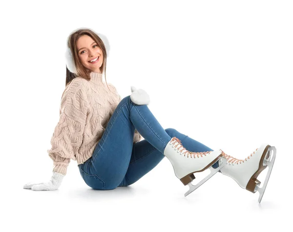 Beautiful young woman on ice skates against white background — Stock Photo, Image