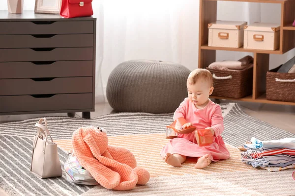 Cute baby girl with female shoes at home — Stock Photo, Image
