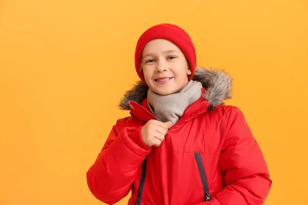 Cute little boy in winter clothes on color background — Stock Photo, Image