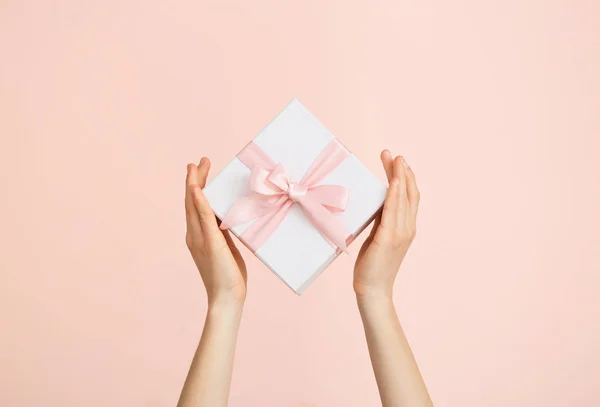 Manos femeninas con hermosa caja de regalo sobre fondo de color — Foto de Stock