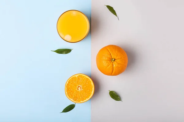 Glass of fresh orange juice and fruit on color background — Stock Photo, Image
