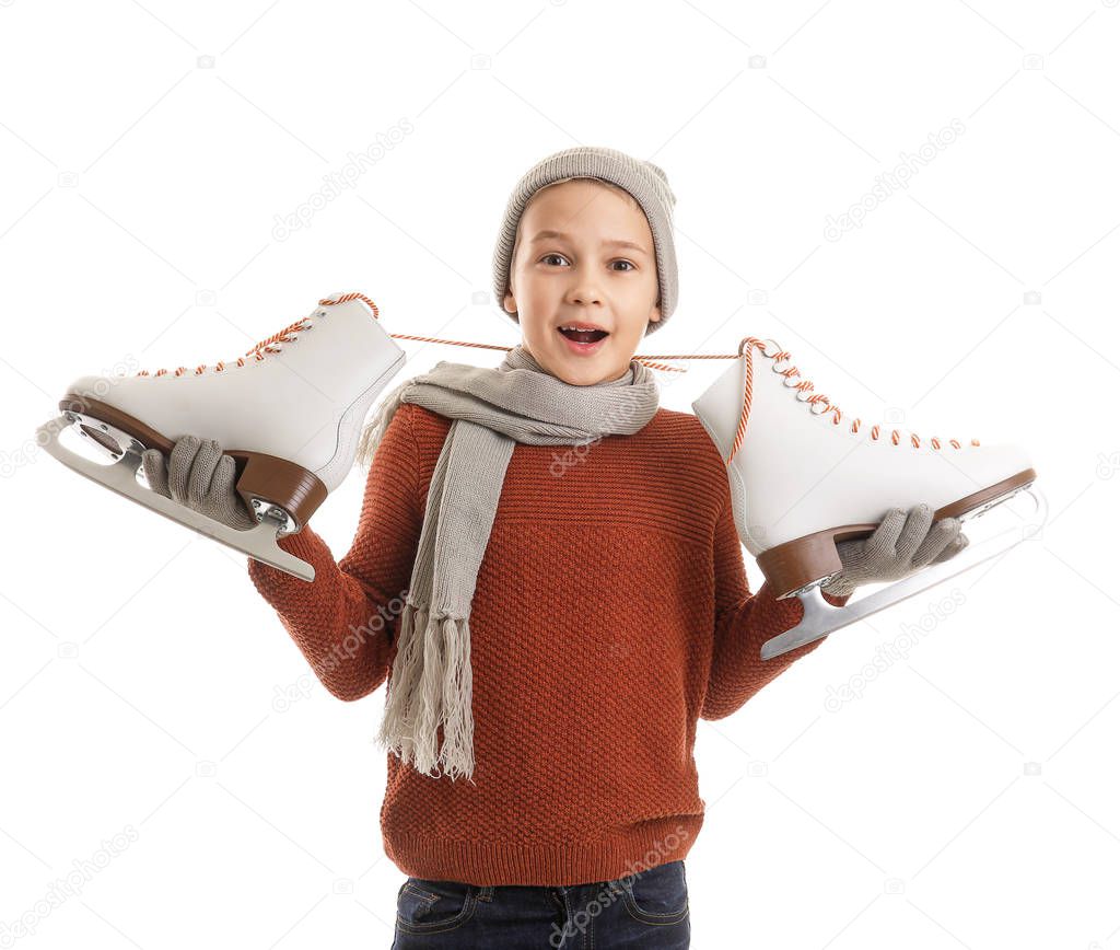 Cute little boy with ice skates against white background