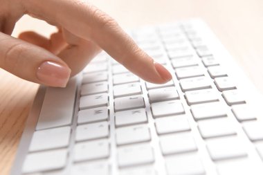 Woman working on modern computer, closeup
