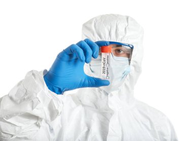 Laboratory worker in protective uniform and with sample of Coronavirus in test tube on white background