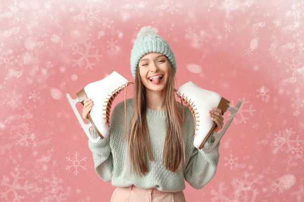 Funny young woman with ice skates on color background — Stock Photo, Image
