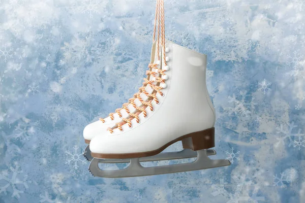 Ice skates on color background