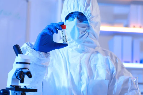 Scientist holding test tube with sample of Coronavirus in laboratory — Stok fotoğraf