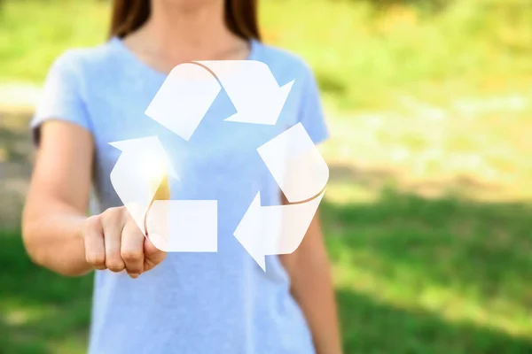 Woman touching symbol of recycling outdoors — Stockfoto