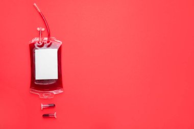 Blood pack for transfusion and test tubes on color background