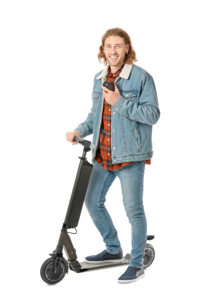 Young man with kick scooter and cup of coffee on white background — ストック写真