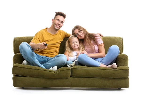 Счастливая молодая семья смотрит телевизор, сидя на диване на белом фоне — стоковое фото