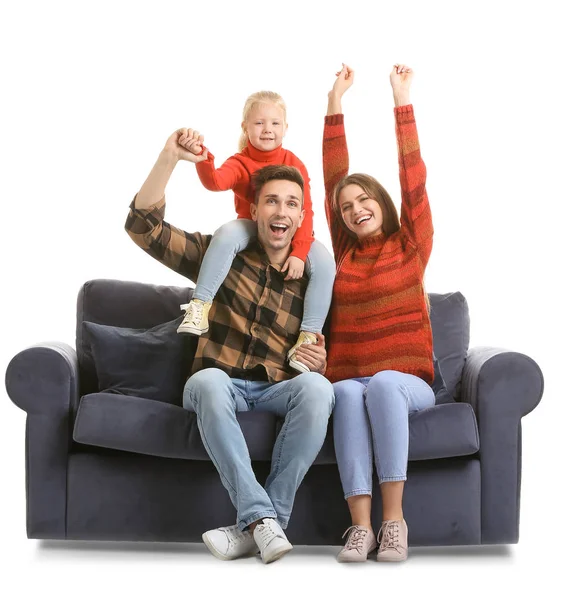 Happy young family sitting on sofa against white background — Stock Photo, Image