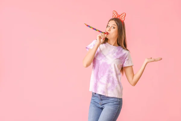 Woman with party whistle on color background. April fools' day celebration — Stock Photo, Image
