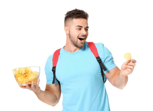 Handsome male student with tasty potato chips on white background — Stock Photo, Image