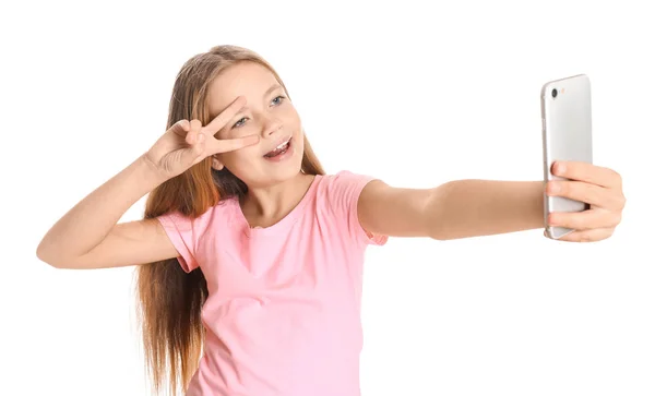 Cute little girl taking selfie on white background — Stock Photo, Image