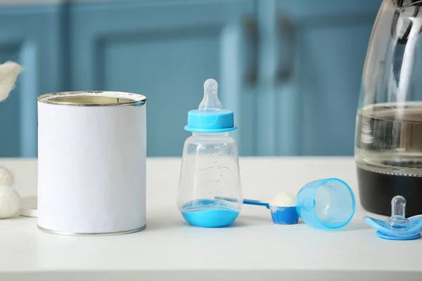 Bottle with baby milk formula on table indoors — 스톡 사진