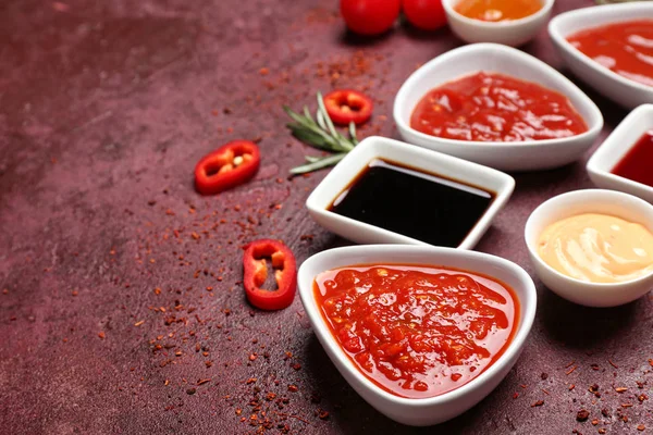 Different tasty sauces on color background — 스톡 사진