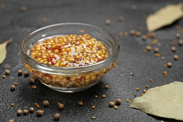 Bowl with tasty Dijon mustard on dark background — Stock Photo, Image