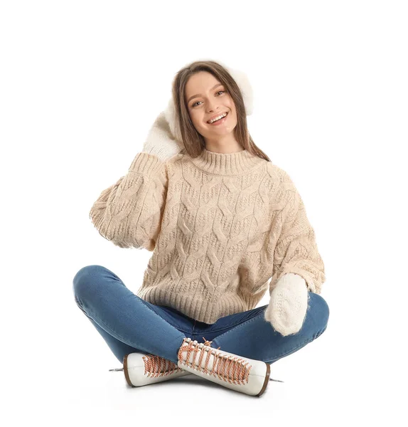 Beautiful young woman on ice skates against white background — Stockfoto