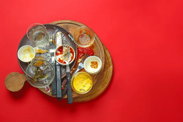 Dirty empty dishes on color background — Stock Photo, Image